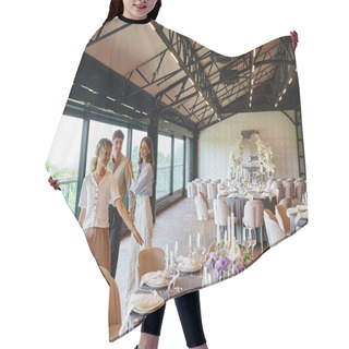 Personality  Smiling Event Organizer Pointing At Festive Tables Near Happy Couple In Decorated Wedding Hall Hair Cutting Cape