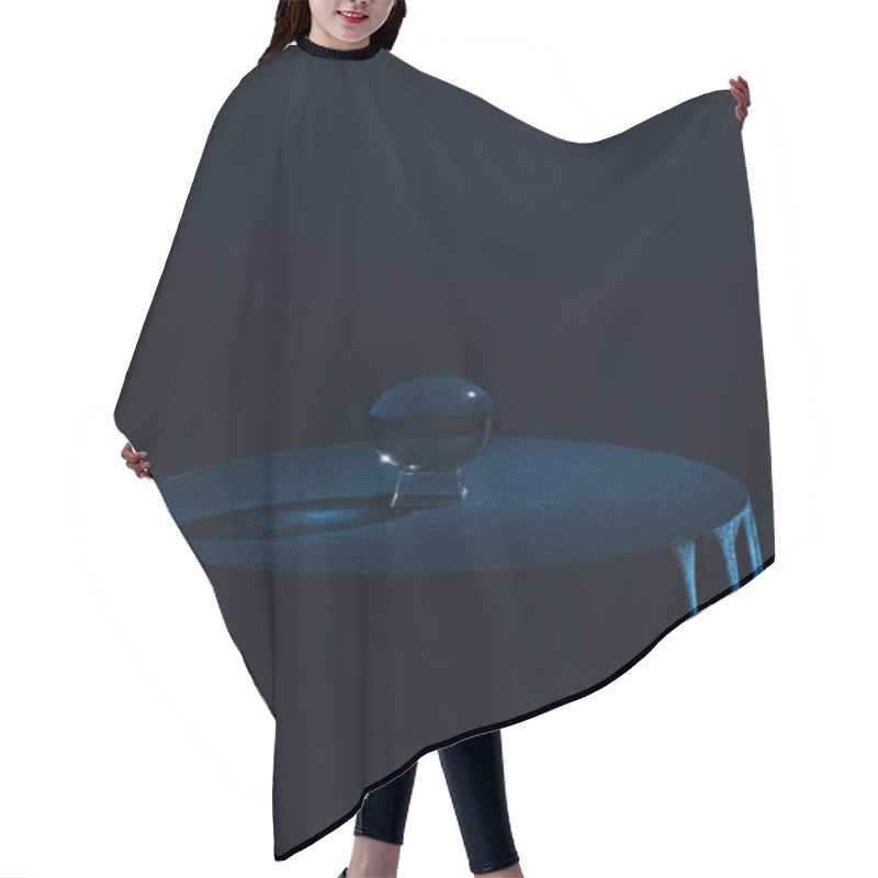 Personality  Crystal ball on round table with dark blue tablecloth on black background hair cutting cape