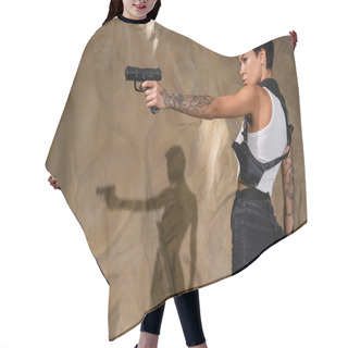 Personality  Side View Of Brunette Tattooed Archaeologist Aiming With Gun Near Rock In Cave Hair Cutting Cape