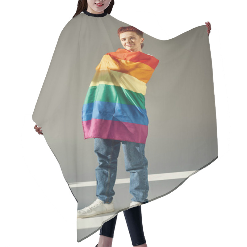 Personality  full length of smiling queer person posing with rainbow colors LGBT flag white standing on grey hair cutting cape