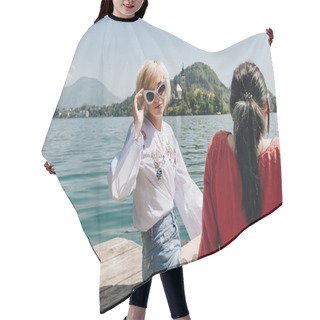 Personality  Beautiful Girl In Sunglasses Looking At Camera While Sitting With Girlfriend On Wooden Pier At Mountain Lake, Bled, Slovenia Hair Cutting Cape