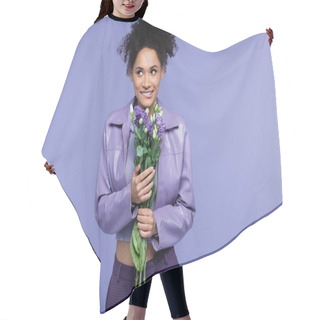 Personality  Happy Young African American Woman Biting Lip And Holding Bouquet Of Flowers Isolated On Purple Hair Cutting Cape