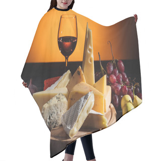 Personality  Different Types Of Cheeses, Glass Of Wine And Fruits On Table On Orange Hair Cutting Cape