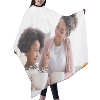Personality  Joyful African American Girl Holding Teddy Bear And Spoon Near Happy Mother Hair Cutting Cape