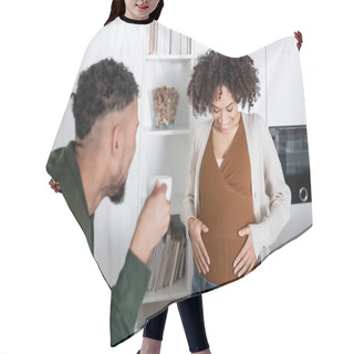 Personality  Blurred African American Man Looking At Pregnant Wife While Holding Cup With Coffee In Kitchen  Hair Cutting Cape