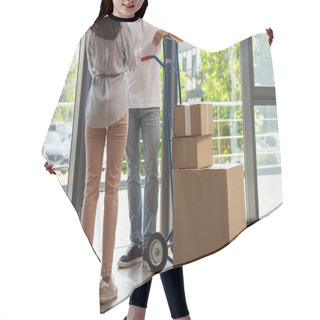Personality  Back View Of Woman Holding Digital Tablet Near Delivery Man Standing Near Delivery Cart With Boxes  Hair Cutting Cape