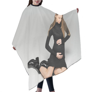 Personality  Fashionable And Fair Haired Pregnant Woman In Black Dress And Boots Touching Belly And Sitting On Grey Background, New Beginnings And Maternity Concept, Mother-to-be Hair Cutting Cape