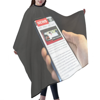 Personality  A Man Holding Mobile Smart Phone With News On Screen. Newspaper  Hair Cutting Cape