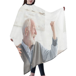 Personality  Happy Senior Man With Hearing Aid Looking Away, Sitting At Home Hair Cutting Cape