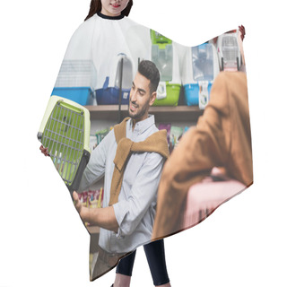 Personality  Smiling Muslim Man Holding Animal Cage Near Blurred Girlfriend In Pet Shop Hair Cutting Cape