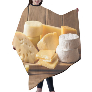 Personality  Various Types Of Cheese On Dark Rustic Wooden Background. Hair Cutting Cape