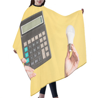 Personality  Cropped View Of Woman Holding Fluorescent Lamp And Calculator In Hands Isolated On Yellow, Energy Efficiency Concept  Hair Cutting Cape