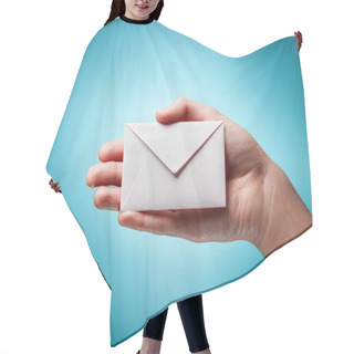 Personality  Woman's Hand Holding Closed Envelope Against Blue Background Hair Cutting Cape