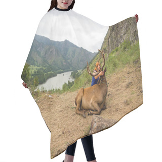Personality  A Young Red-haired Girl Dressed In Sports Clothes Stroking The Horns And Skin Of A Deer Maral Who Lies On A Mountain Tied With A Bridle In The Mountains Of The Altai Hair Cutting Cape