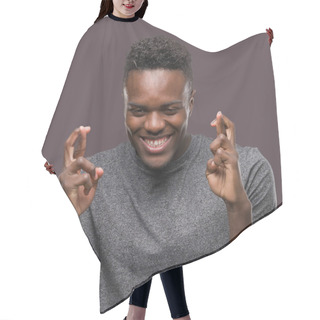 Personality  Young African American Man Wearing Grey T-shirt Smiling Crossing Fingers With Hope And Eyes Closed. Luck And Superstitious Concept. Hair Cutting Cape