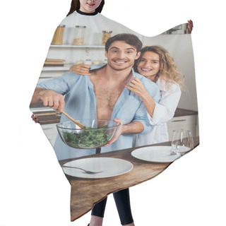 Personality  Happy Couple Embracing While Cooking Salad Together In Kitchen Hair Cutting Cape