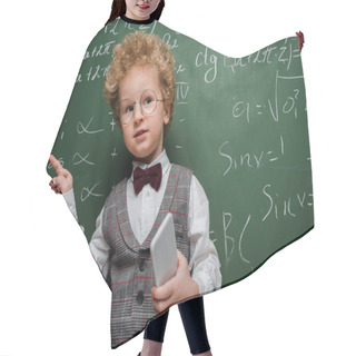 Personality  Smart Child In Suit And Bow Tie Holding Smartphone And Pointing With Finger Near Chalkboard With Mathematical Formulas  Hair Cutting Cape