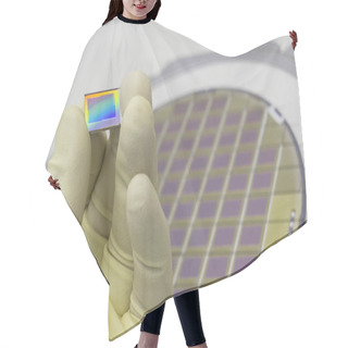 Personality  Silicon Wafer With Microchips, Fixed In A Holder With A Steel Frame On A Gray Background After The Process Of Dicing. Microchip Separation With Tweezer In Hand. Hair Cutting Cape