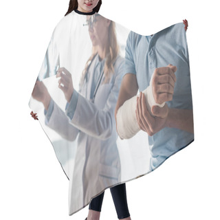 Personality  Selective Focus Of Injured Man Near Attractive Doctor Looking At X-ray  Hair Cutting Cape