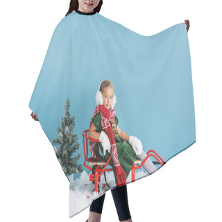 Personality  Girl In Winter Earmuffs And Scarf Sitting In Sleigh On Snow Near Pines On Blue Hair Cutting Cape