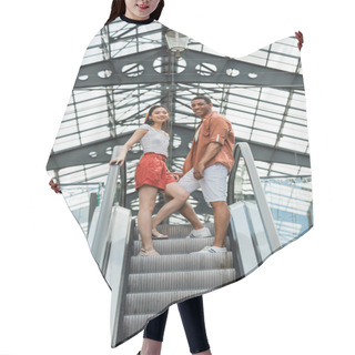 Personality  Low Angle View Of Interracial Couple In Stylish Summer Clothes Smiling At Camera On Escalator Hair Cutting Cape