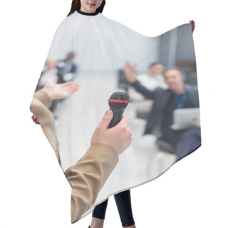 Personality  Young Lecturer With Microphone Pointing At Blurred Audience During Seminar Hair Cutting Cape