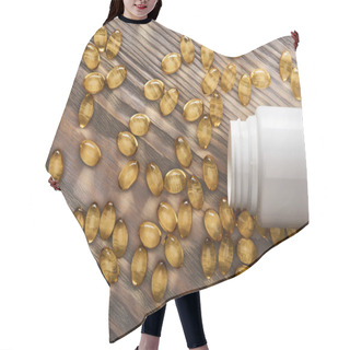 Personality  Golden Fish Oil Capsules Scattered From Plastic Container On Wooden Table Hair Cutting Cape
