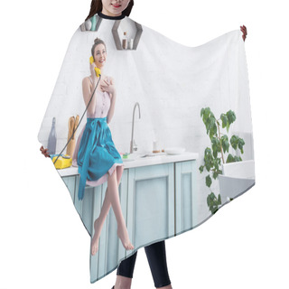 Personality  Happy Young Woman In Apron Sitting On Table And Talking On Retro Yellow Telephone In Kitchen   Hair Cutting Cape