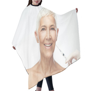 Personality  Beautiful Smiling Caucasian Senior Woman Standing In Front Of Gray Background And Taking A Shot Of Anti Age Product. Beauty Photography. Hair Cutting Cape