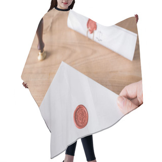 Personality  Cropped View Of Lawyer Holding Envelope With Wax Seal Near Blurred Stamper Hair Cutting Cape