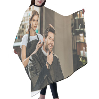 Personality  Young Female Hairstylist And Handsome Smiling Man Looking At Mirror In Beauty Salon Hair Cutting Cape