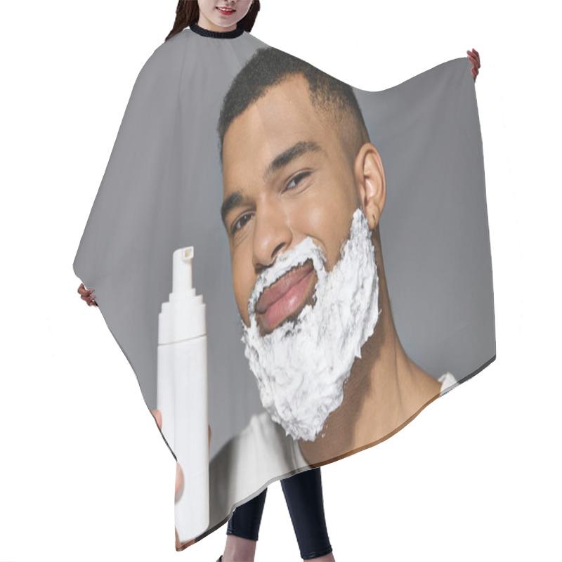 Personality  Handsome Man With Beard Holds Shaving Bottle. Hair Cutting Cape