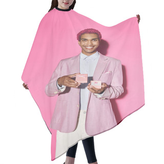 Personality  Cheerful Young Man Posing Unnaturally With Present In His Hands Smiling At Camera On Pink Backdrop Hair Cutting Cape