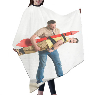 Personality  Father Holding Son With Toy Rocket On Back At Home Hair Cutting Cape