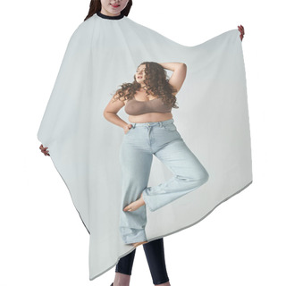 Personality  Attractive Curvy Woman In Brown Bra And Blue Jeans Posing With Bent Leg And Putting Hand Behind Head Hair Cutting Cape