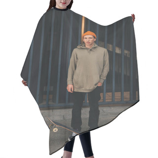 Personality  Skateboarder In Oversized Hoody With Board Standing In Front Of Metal Fence Hair Cutting Cape