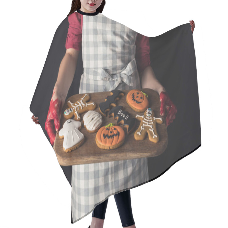 Personality  girl holding tray with halloween cookies hair cutting cape