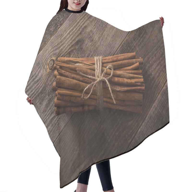 Personality  top view of cinnamon sticks in bunch on wooden rustic table hair cutting cape