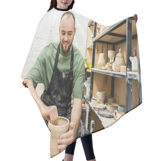 Personality  Joyful Bearded Artisan In Apron Shaping Clay Vase On Pottery Wheel Near Rack In Workshop Hair Cutting Cape