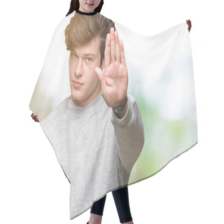 Personality  Young Handsome Sporty Man Wearing Sweatshirt Over Isolated Background Doing Stop Sing With Palm Of The Hand. Warning Expression With Negative And Serious Gesture On The Face. Hair Cutting Cape