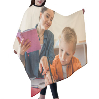 Personality  Smiling Teacher Pointing With Finger Near Kid Writing Dictation In Montessori School Hair Cutting Cape