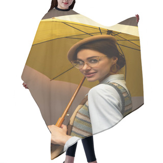 Personality  Joyful Young Woman In Beret And Eyeglasses Holding Yellow Umbrella On Grey Hair Cutting Cape