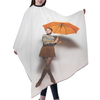 Personality  Full Length Of Smiling Young Woman In Striped Turtleneck And Skirt Posing With Orange Umbrella On Grey Hair Cutting Cape