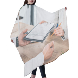 Personality  Cropped View Of Businessman And Businesswoman Holding Compensation Claim Form And Pencil At Workplace Hair Cutting Cape