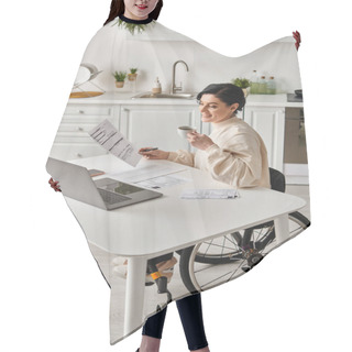 Personality  A Woman In A Wheelchair Is Sitting At A Table In Her Kitchen, Focused On Working On Her Laptop Remotely. Hair Cutting Cape