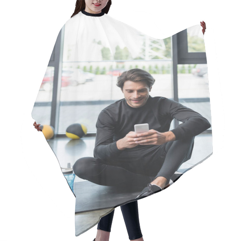 Personality  Cheerful Sportsman Using Cellphone Near Sports Bottle On Fitness Mat In Gym  Hair Cutting Cape