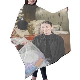 Personality  Positive Female Volunteer Looking At Camera While Holding Plastic Bag With Trash In Blurred Waste Disposal Station At Background, Garbage Sorting And Recycling Concept Hair Cutting Cape