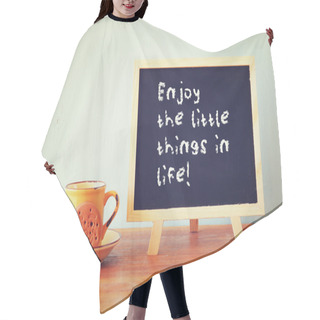 Personality  Blackboard With The Phrase Enjoy The Little Things In Life Next To Coffee Cup Over Wooden Table Hair Cutting Cape