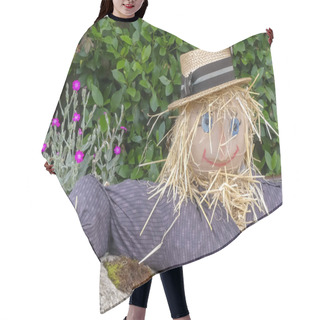 Personality  Happy Straw Haired Rustic Scarecrow With Boater, Resting With Arm On The Top Of A Moss Covered Wall. Naturally Growing Flowers And Foliage Background. Landscape Image With Space For Text. England. Hair Cutting Cape