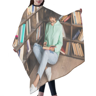 Personality  Curly African American Student In Eyeglasses Sitting On Floor And Reading Book In Library  Hair Cutting Cape